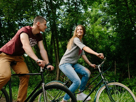 Couple on bikes. Young happy couple cycling at outdoors.