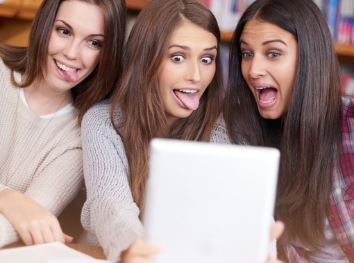 Women, students or tablet selfie in college library or bonding together for crazy update on social media. Learners, touchscreen or post online as goofy friends or solidarity with care in university